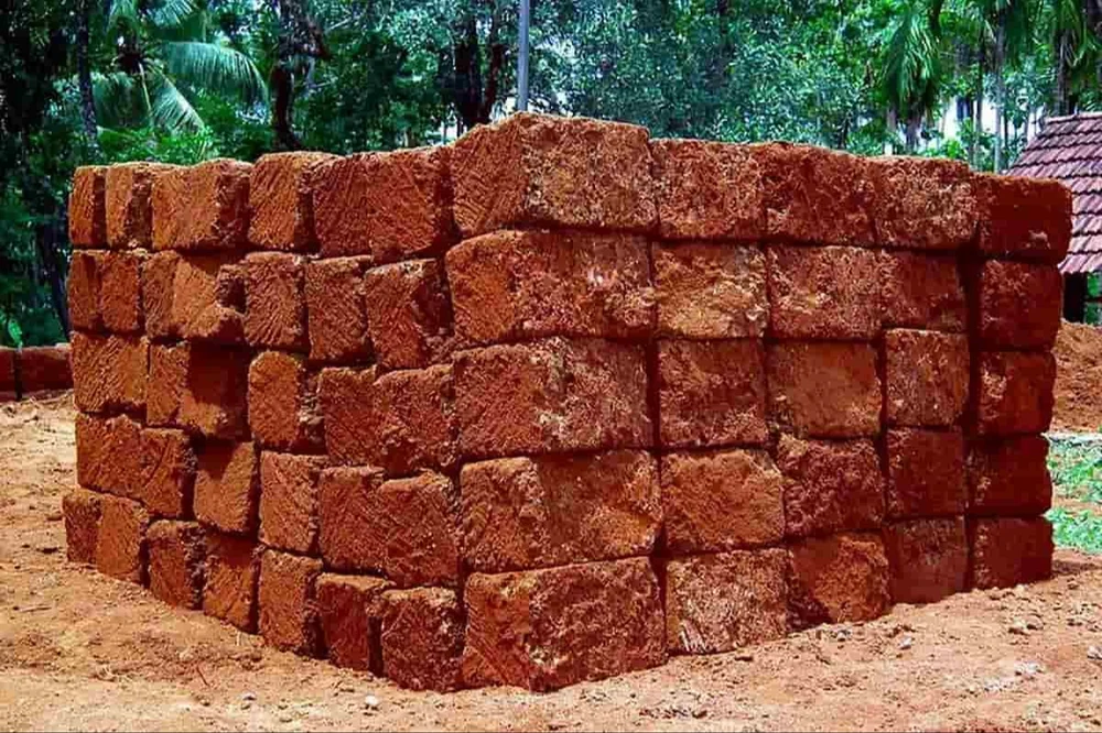 Stack of red laterite stone blocks for sale in Nuvem, Goa